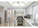 A functional kitchen featuring stainless steel appliances and granite countertops at 8413 Moulton Dr, Port Richey, FL 34668