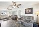 Spacious living room with comfortable seating and ceiling fans at 8413 Moulton Dr, Port Richey, FL 34668