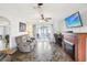 Comfortable living room featuring tile flooring, a fireplace, and sliding glass doors to the outdoors at 8413 Moulton Dr, Port Richey, FL 34668