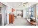 Sunroom with ceiling fan, dresser, and sliding glass doors to the backyard at 8413 Moulton Dr, Port Richey, FL 34668