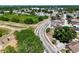 An aerial view captures the neighborhood street, sidewalks and common area with trees and playground at 9206 Wood Lake Blvd, Tampa, FL 33615