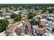An aerial view showcases homes with mature trees and some backyard pools in a residential neighborhood at 9206 Wood Lake Blvd, Tampa, FL 33615
