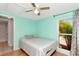 Cozy bedroom features a ceiling fan, window, and soft, inviting decor that adds a relaxing ambiance to the space at 9206 Wood Lake Blvd, Tampa, FL 33615