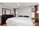 Comfortable bedroom featuring wood floors, large dresser, and natural light at 9206 Wood Lake Blvd, Tampa, FL 33615