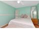 Charming bedroom with light blue walls, hardwood floors, and natural lighting at 9206 Wood Lake Blvd, Tampa, FL 33615