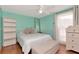 Bright, cozy bedroom with light blue walls, a ceiling fan, and a comfortable bed at 9206 Wood Lake Blvd, Tampa, FL 33615