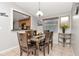 Dining room adjacent to the kitchen, featuring a wood table set for six and a view of the backyard at 9206 Wood Lake Blvd, Tampa, FL 33615