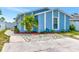 Charming blue home with well-maintained landscaping, complemented by a spacious driveway for easy parking at 9206 Wood Lake Blvd, Tampa, FL 33615