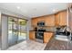 Functional kitchen boasts stainless steel appliances, tile backsplash, and a view of the screened-in patio for seamless indoor/outdoor living at 9206 Wood Lake Blvd, Tampa, FL 33615