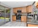 Modern kitchen featuring stainless steel appliances, granite countertops, and access to the outdoor patio at 9206 Wood Lake Blvd, Tampa, FL 33615