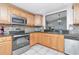 Well-equipped kitchen featuring stainless steel appliances, tiled backsplash, and granite countertops at 9206 Wood Lake Blvd, Tampa, FL 33615