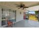 Relaxing screened patio features a ceiling fan, tile flooring and a serene outdoor retreat, ideal for dining and entertaining at 9206 Wood Lake Blvd, Tampa, FL 33615