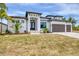 Stunning modern home with a three-car garage, beautiful landscaping, and a striking entrance at 9412 President Cir, Port Charlotte, FL 33981