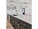 Modern kitchen featuring a large marble island with dark cabinets and gold hardware at 9412 President Cir, Port Charlotte, FL 33981