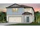 Charming two-story home featuring a two-car garage and a welcoming entryway at 9759 Crescent Moon Dr, Riverview, FL 33578