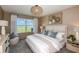 Serene main bedroom with a large window overlooking a beautiful landscape, plus elegant decor and soft lighting at 9768 Crescent Moon Dr, Riverview, FL 33578
