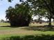 Lush community greenspace with mature trees offering ample shade and relaxation areas on a sunny day at 9825 41St N St # 9825, Pinellas Park, FL 33782