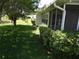 Charming screened-in porch adjacent to a vibrant green yard offers a serene and inviting outdoor space at 9825 41St N St, Pinellas Park, FL 33782