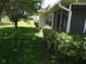 Charming screened-in porch adjacent to a vibrant green yard offers a serene and inviting outdoor space at 9825 41St N St, Pinellas Park, FL 33782