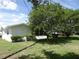 Exterior side view of house surrounded by trees and a lawn at 9825 41St N St, Pinellas Park, FL 33782