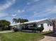 Charming single-story home with a well-manicured lawn and tropical landscaping in a sunny neighborhood at 9825 41St N St, Pinellas Park, FL 33782