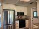 Updated kitchen featuring stainless steel appliances, granite countertops, and white shaker cabinets at 9825 41St N St, Pinellas Park, FL 33782