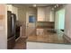 Updated kitchen featuring stainless steel appliances, granite countertops, and white cabinets at 9825 41St N St, Pinellas Park, FL 33782