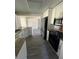 Well-lit kitchen with stainless steel appliances, granite countertops, and white cabinets offers modern appeal at 9825 41St N St, Pinellas Park, FL 33782