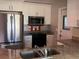 Renovated kitchen featuring stainless steel appliances, granite countertops, and white shaker cabinets at 9825 41St N St # 9825, Pinellas Park, FL 33782