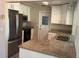 Renovated kitchen featuring stainless steel appliances, granite countertops, and white shaker cabinets at 9825 41St N St, Pinellas Park, FL 33782