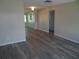 A spacious living room with new flooring throughout and neutral wall colors at 9825 41St N St, Pinellas Park, FL 33782