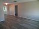 Open living room with wood flooring, neutral walls, and a glimpse into adjoining rooms at 9825 41St N St, Pinellas Park, FL 33782
