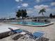 A community pool with lounge chairs and a covered seating area at 9825 41St N St, Pinellas Park, FL 33782