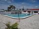 Community outdoor pool area and facilities surrounded by palm trees and manicured grounds at 9825 41St N St, Pinellas Park, FL 33782