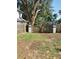 View of the backyard double-gate entrance with decorative lighting and mature trees at 1004 Hollyberry Ct, Brandon, FL 33511
