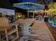 Inviting backyard with a picnic table, ambient lighting, and lush landscaping at 1004 Hollyberry Ct, Brandon, FL 33511