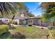 Back yard with screened in back porch and stone pathway at 1004 Hollyberry Ct, Brandon, FL 33511