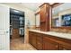 Bathroom boasts dual sinks, wood cabinets, and a walk-in closet for ample storage at 1004 Hollyberry Ct, Brandon, FL 33511