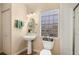 Bright bathroom featuring a pedestal sink, updated fixtures, and a window for natural light at 1004 Hollyberry Ct, Brandon, FL 33511