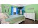 Bright bedroom featuring colorful walls, a comfortable bed, and charming beach-themed decor at 1004 Hollyberry Ct, Brandon, FL 33511