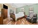 Bright bedroom features a ceiling fan, natural light, and a charming accent wall at 1004 Hollyberry Ct, Brandon, FL 33511