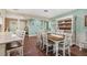 The dining room has hardwood floors, a large table with seating for eight, and a buffet at 1004 Hollyberry Ct, Brandon, FL 33511