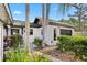 Charming home exterior featuring fresh landscaping, a paved walkway, and modern architectural details at 1004 Hollyberry Ct, Brandon, FL 33511