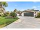 Well-maintained one-story home featuring a spacious driveway, two-car garage, and beautifully landscaped front yard at 1004 Hollyberry Ct, Brandon, FL 33511