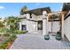 Inviting exterior of a well-maintained home featuring a stone paver walkway, pillars, and lush landscaping at 1004 Hollyberry Ct, Brandon, FL 33511