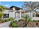 Charming single-story home featuring a covered front entrance, lush landscaping, and an attached two-car garage at 1004 Hollyberry Ct, Brandon, FL 33511