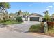 Charming single-story home featuring a manicured lawn, mature trees, and a two-car garage at 1004 Hollyberry Ct, Brandon, FL 33511