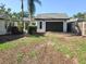 Exterior view of the house with a one-car garage, driveway, and landscaping at 1004 Hollyberry Ct, Brandon, FL 33511