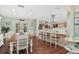 Open kitchen and dining area with stainless appliances, breakfast bar, hardwood floors, and ample seating at 1004 Hollyberry Ct, Brandon, FL 33511