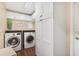 Practical laundry room equipped with a washer, dryer, and ample storage cabinets at 1004 Hollyberry Ct, Brandon, FL 33511